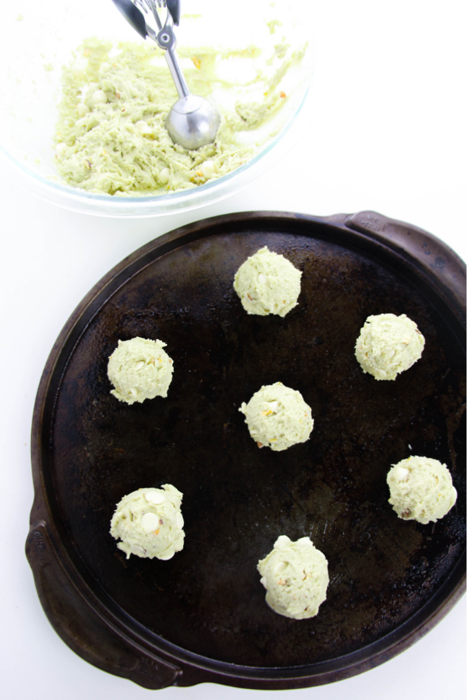 green cookie dough balls on a skillet