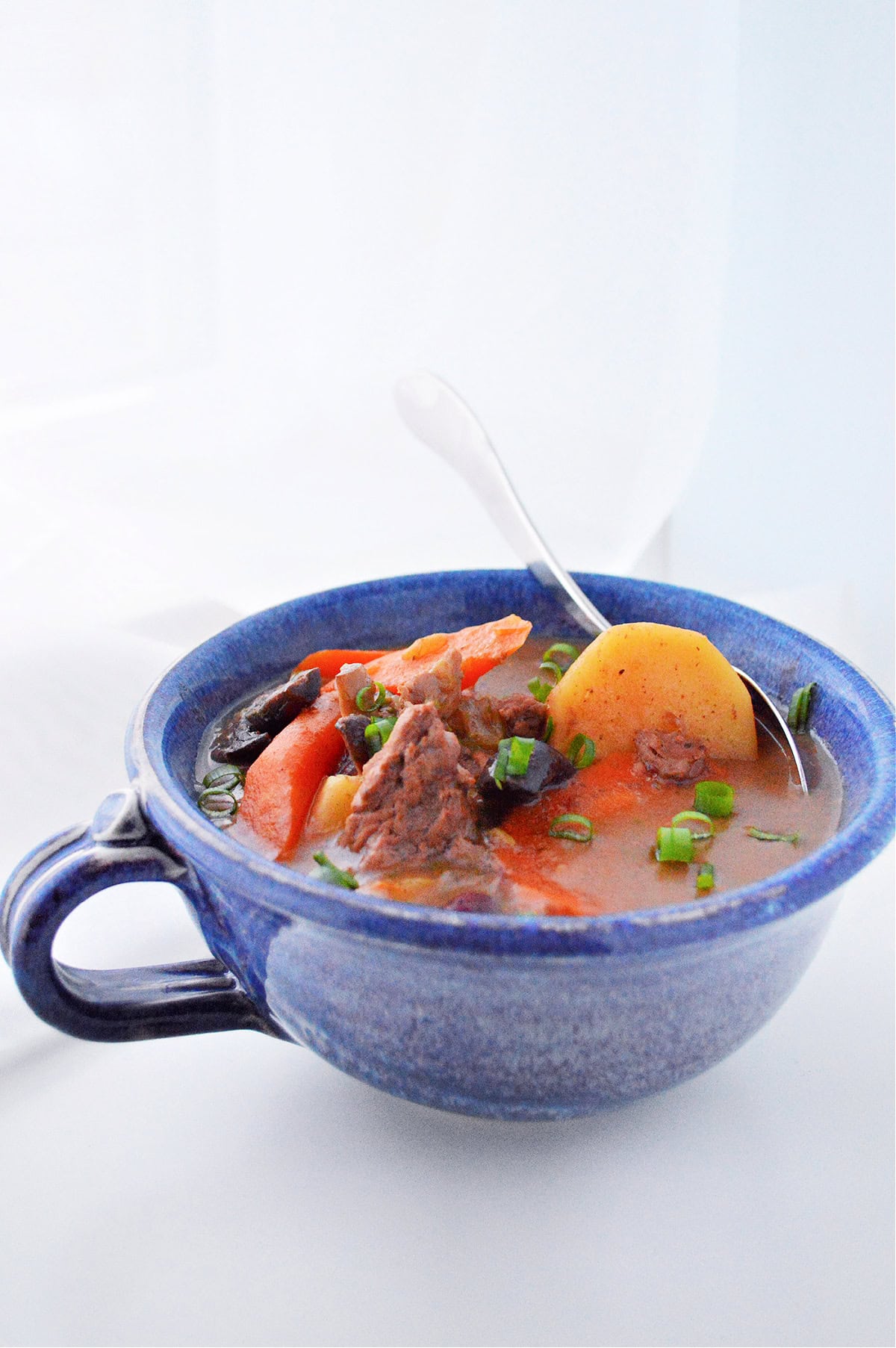 Slow Cooker Beef Vegetable Stew in a blue bowl