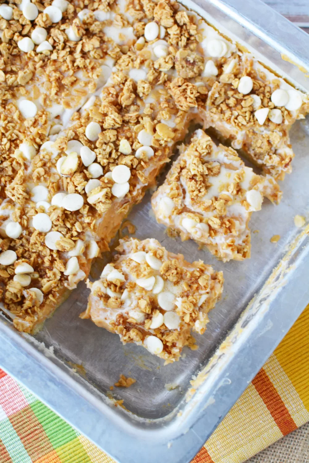 Sweet Potato Cheesecake Bars topped with crumbly topping in a baking pan