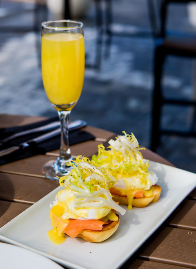 eggs benedict and mimosas on a table
