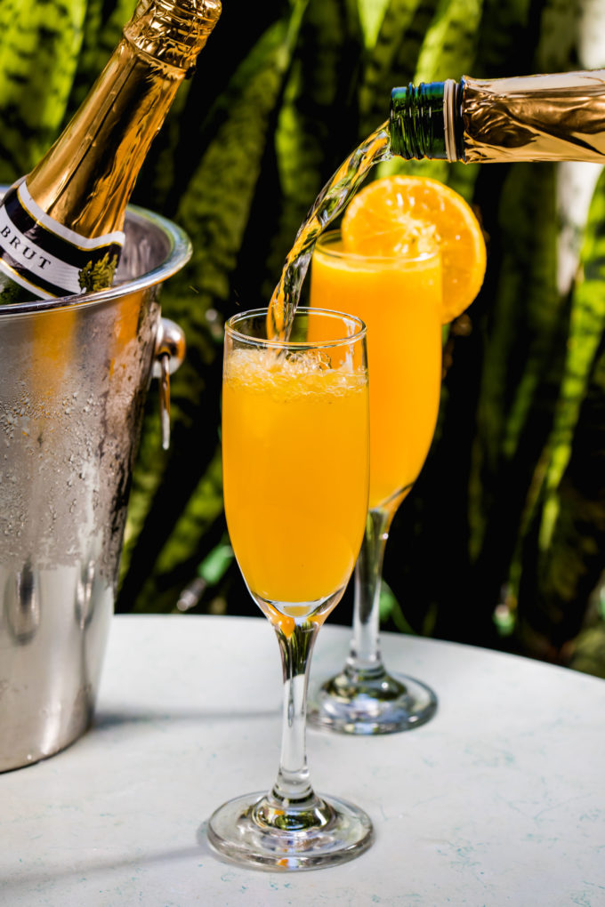 glasses of mimosas and a bottle of champagne at Copper Bar 29 in Coral Gables