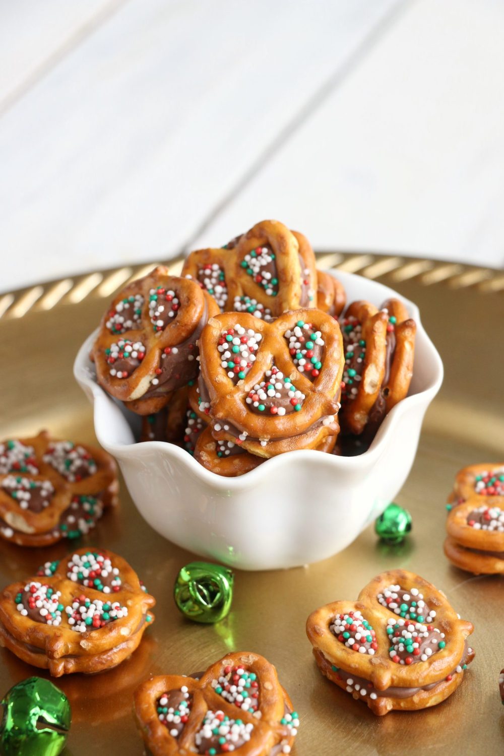 mini pretzels with a rolo candy and green and red sprinkles