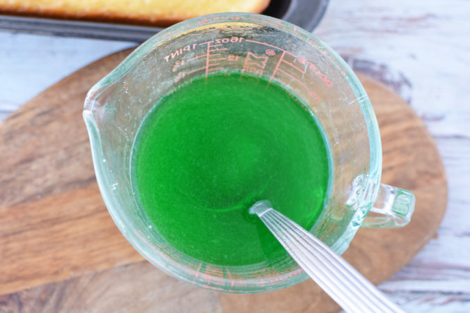 lime green JELLO dissolved in a glass measuring cup