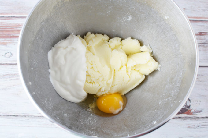 Add butter and sugar to a mixing bowl and beat well. Add egg and sour cream and beat well.