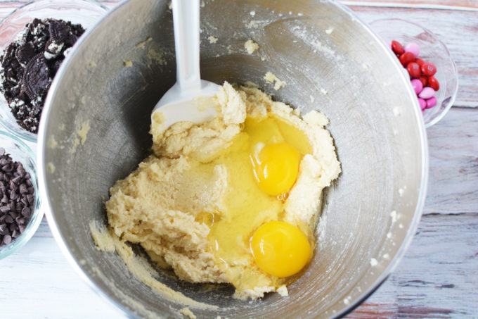 butter, sugar and brown sugar in a stainless steel mixing bowl with eggs