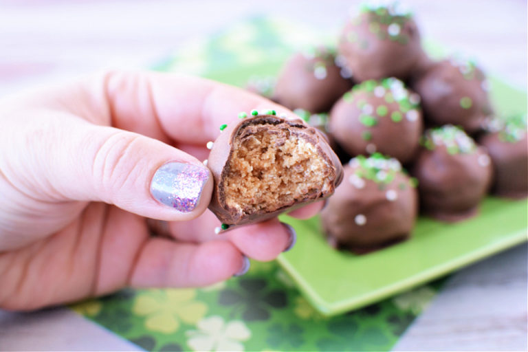 Milk chocolate balls with saint patricks day sprinkles on a green plate
