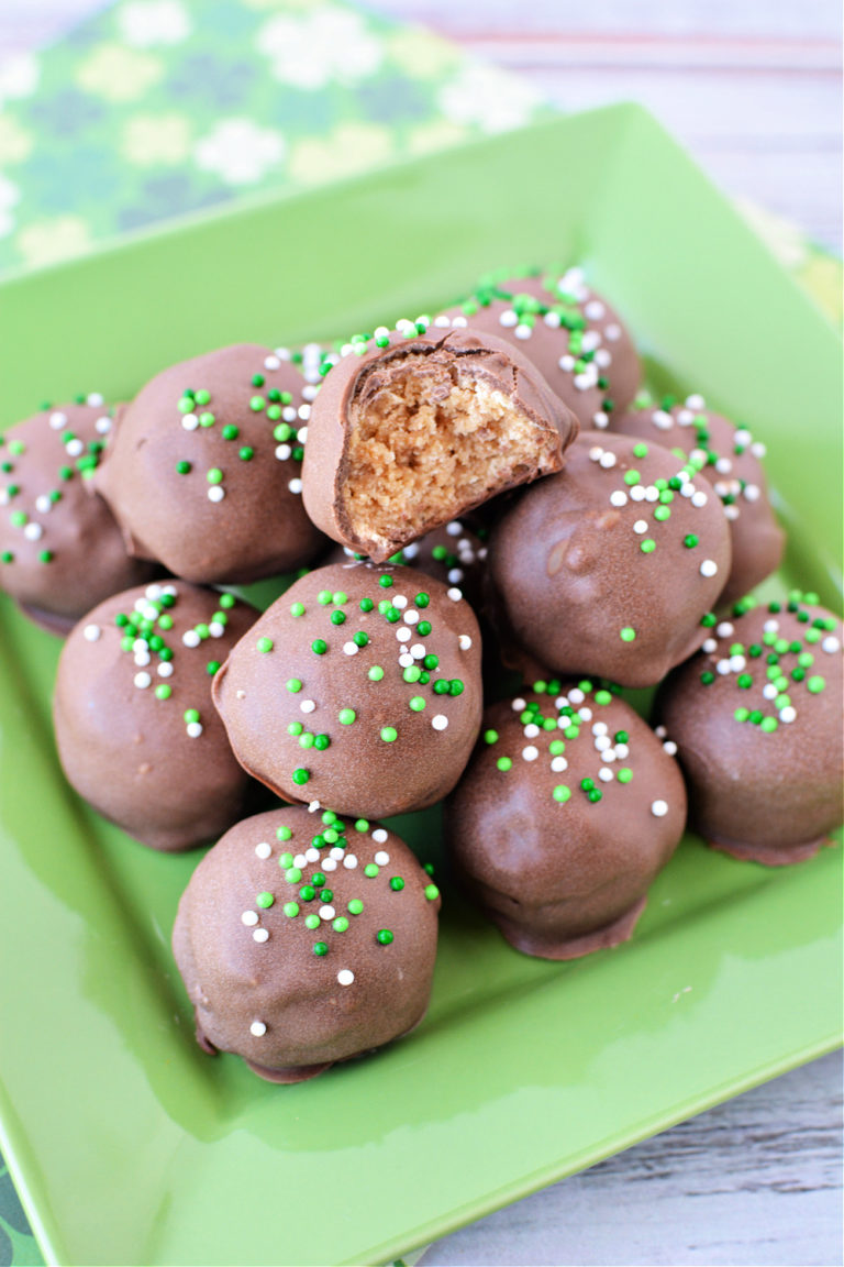 Milk chocolate balls with saint patricks day sprinkles on a green plate