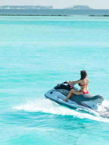 person riding a jetski in blue waters