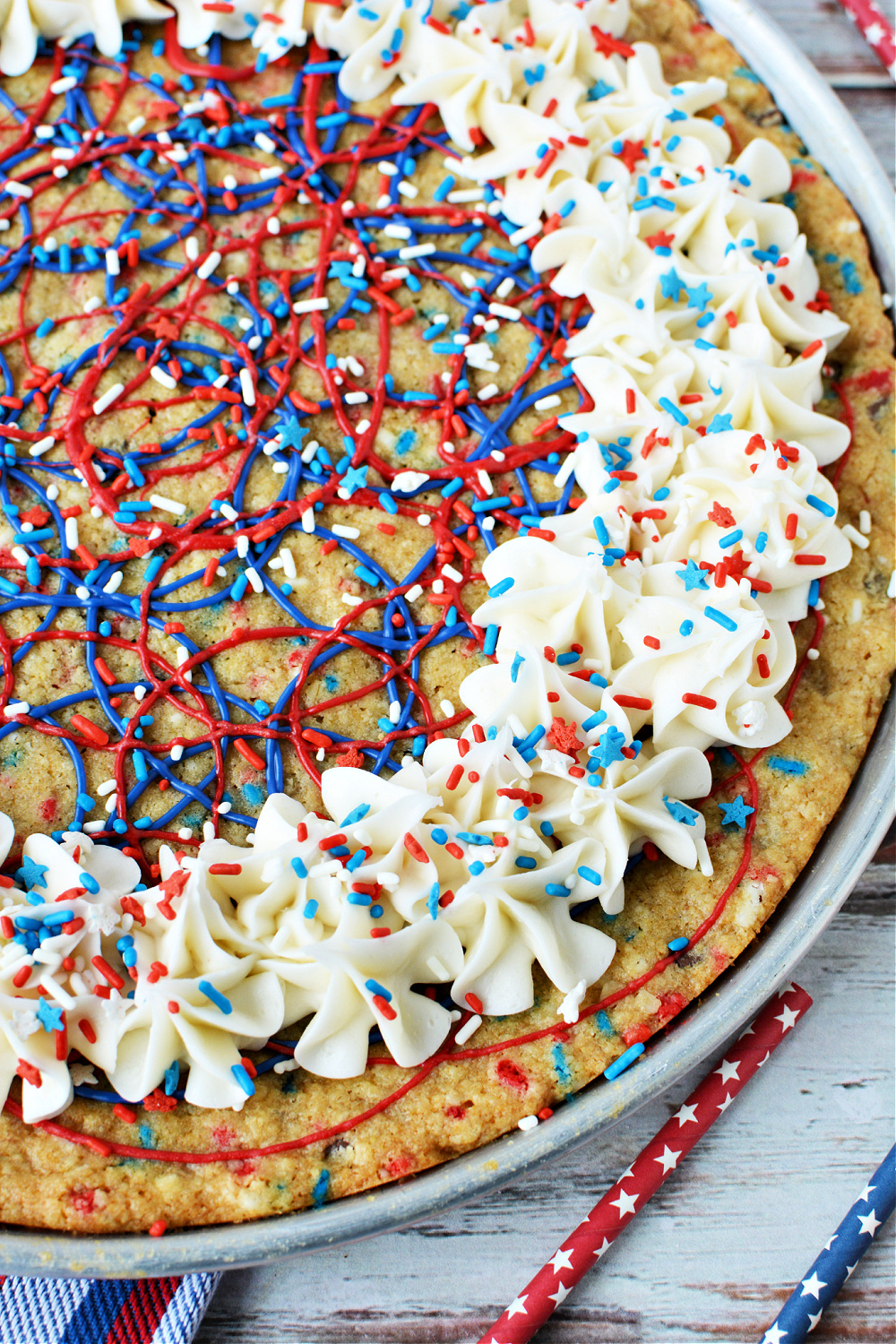 A close-up of the oatmeal chocolate chip cookie pizza decorated with frosting