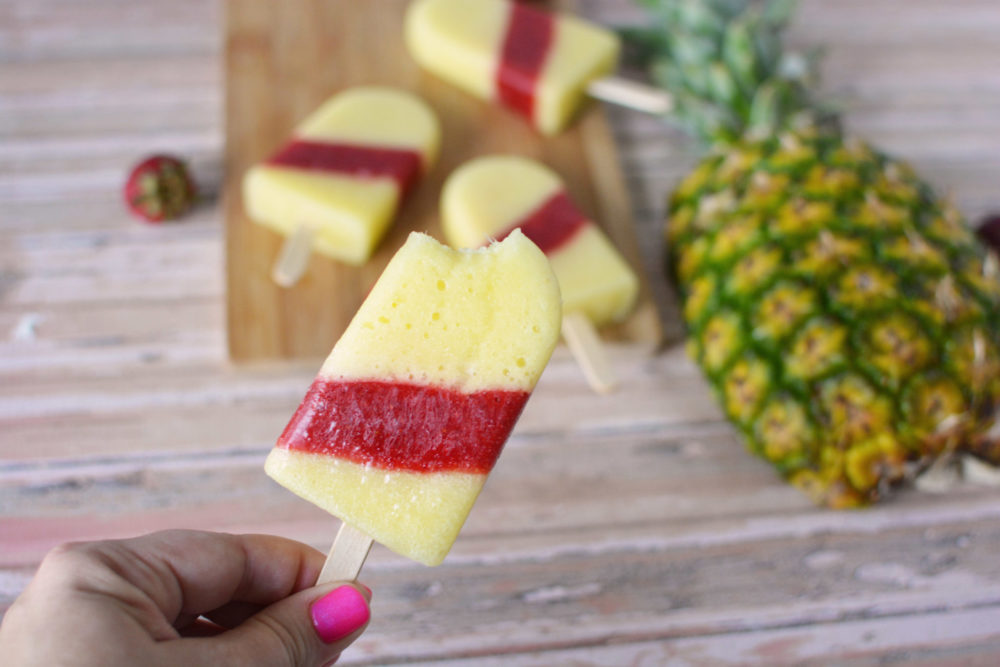 popsicles layered with pineapple and strawberry.