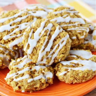 Pumpkin Oatmeal Cookies topped with drizzled white icing