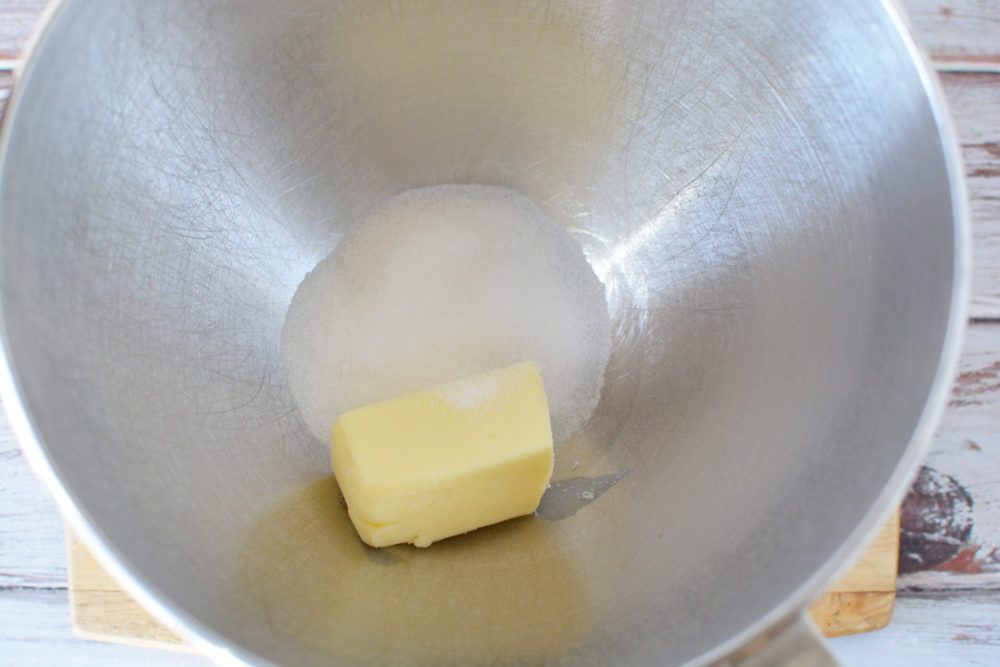Butter and sugar in the bottom of a mixing bowl