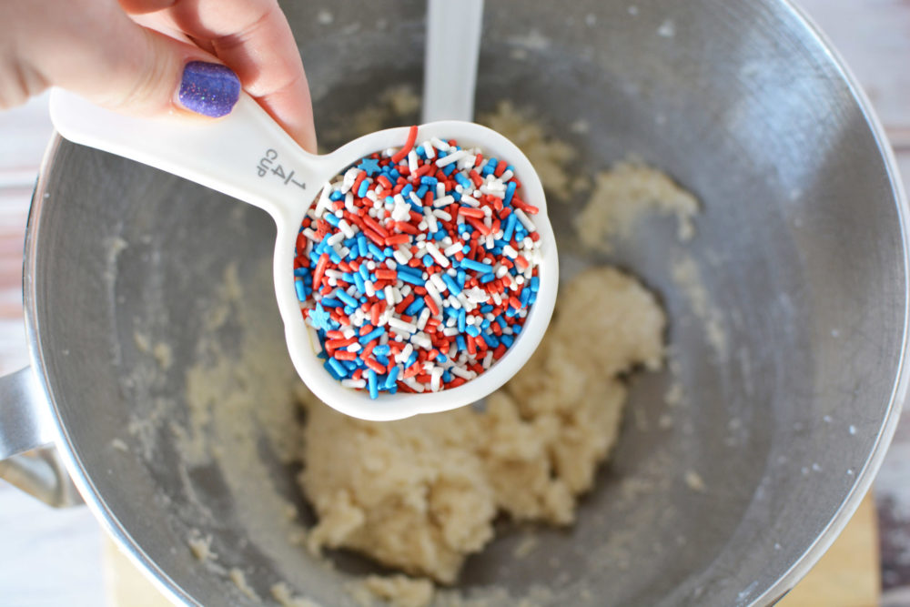 Adding red, white, and blue sprinkles to edible cookie dough