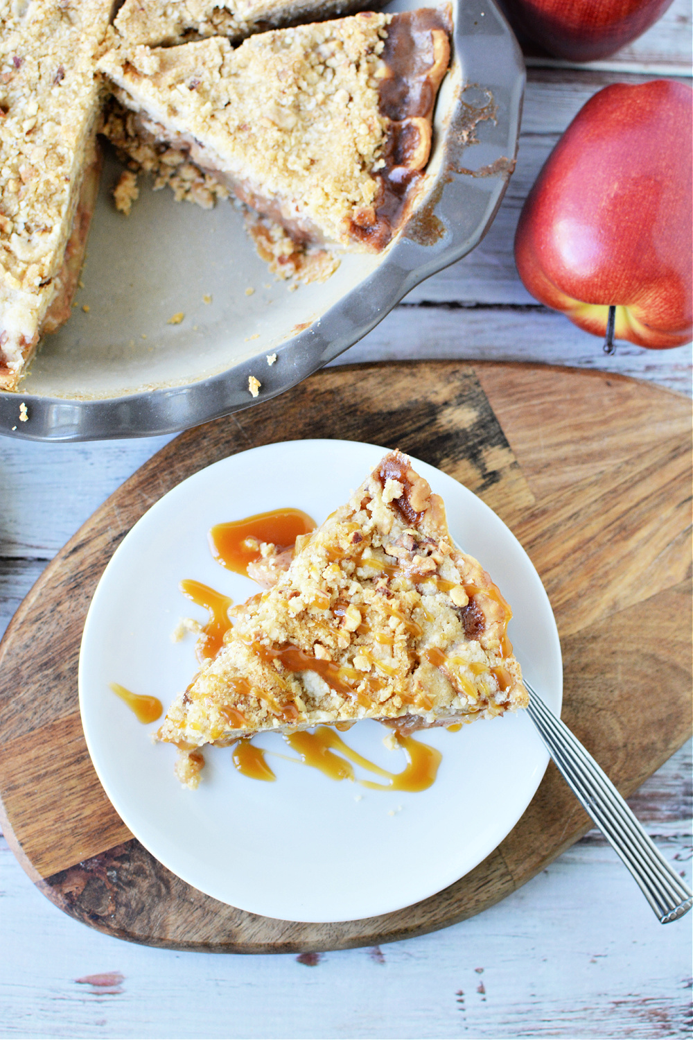 a big piece of apple pie with streusel on top
