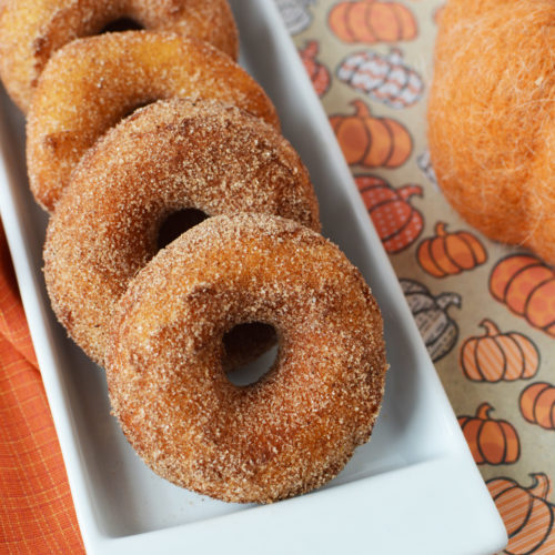 Pumpkin Spice Donuts laid out on a white platter