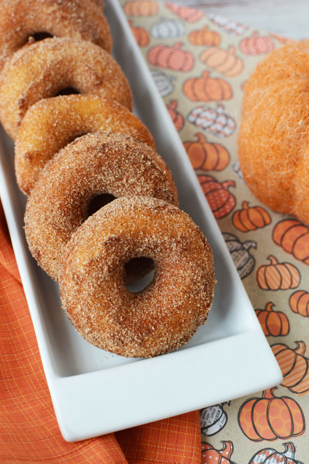 Pumpkin Spice Donuts laid out on a white platter