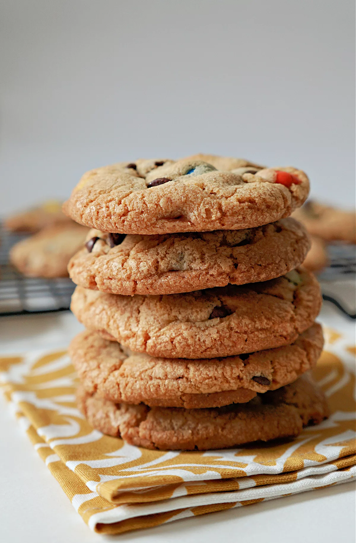 golden brown cookies with chocolate chips and M&Ms candies in a stack