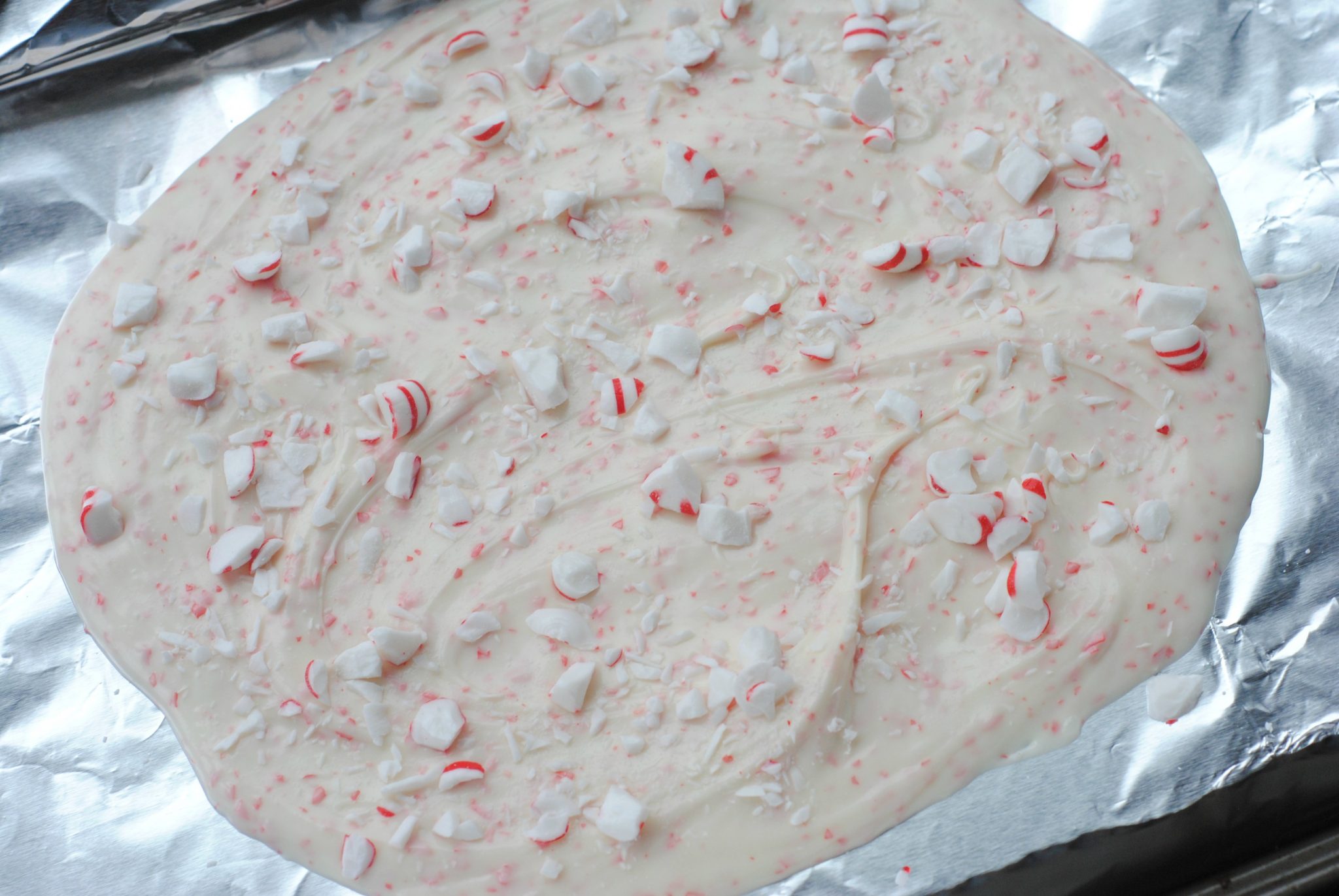 white chocolate and peppermint candies melted on tin foil