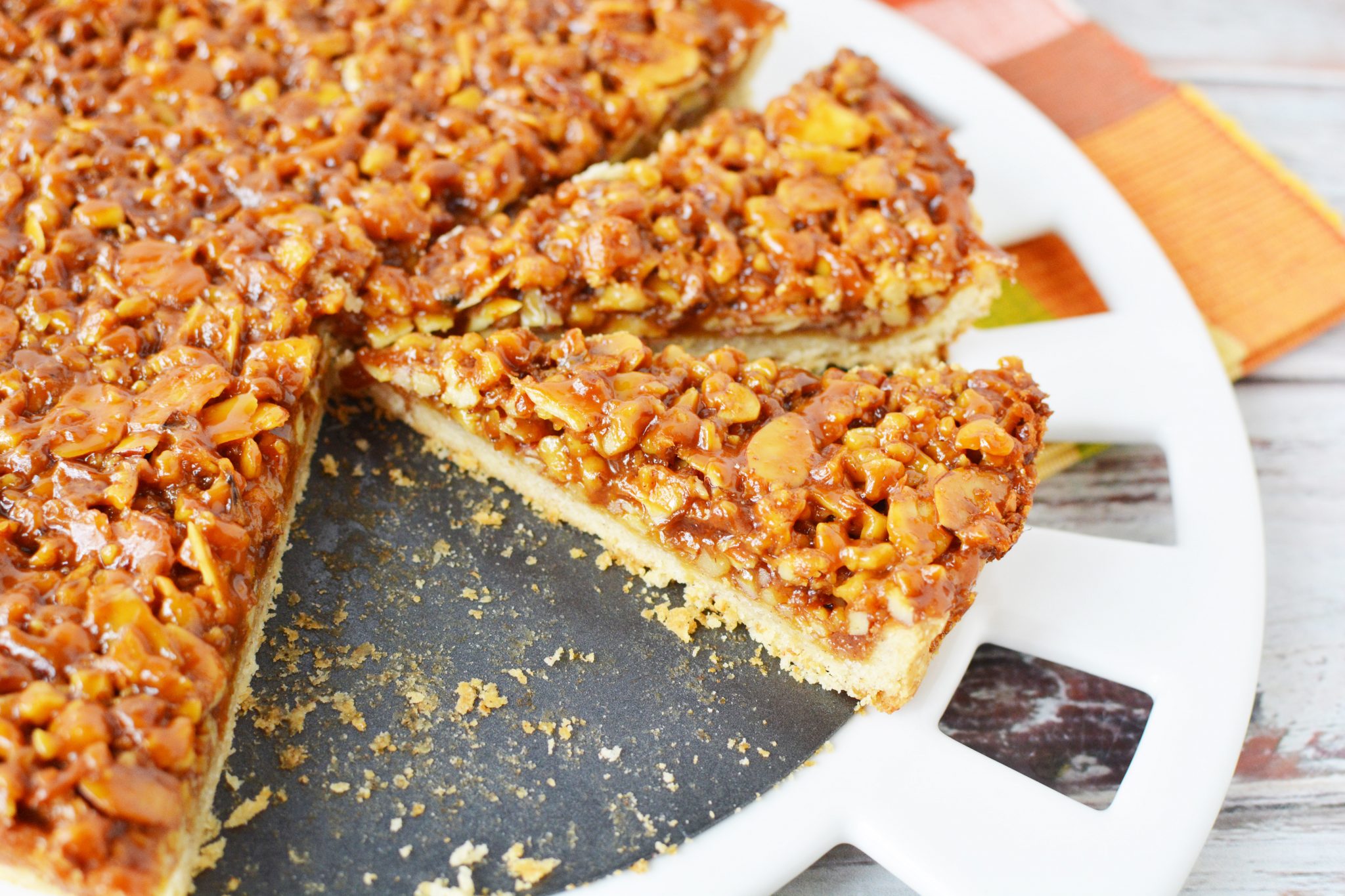 slices of tart covered in caramel and chopped nuts