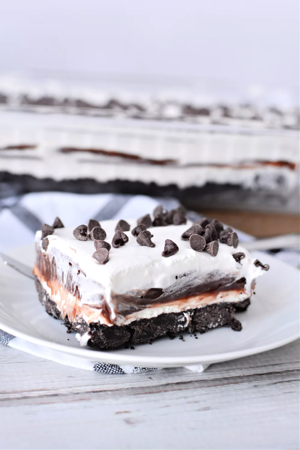 Chocolate Lasagna layer cake with whipped topping and chocolate chips on top