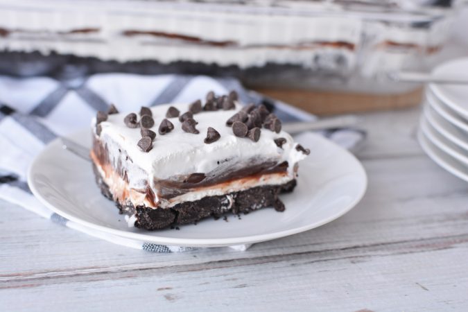 layered chocolate dessert with cool whip topping and mini chocolate chips on top