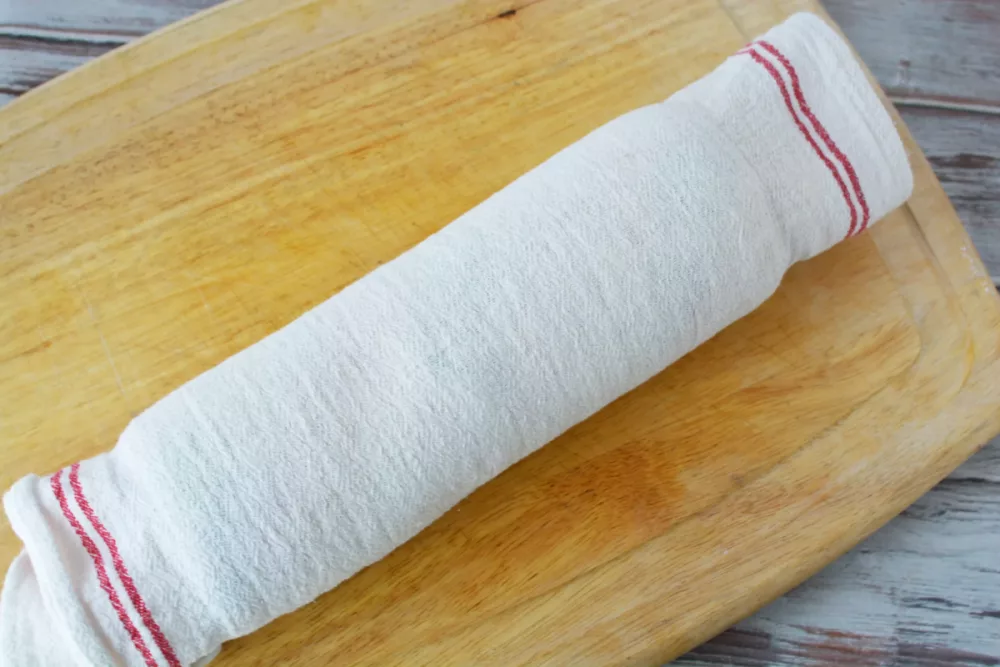 white towel on a wooden cutting board