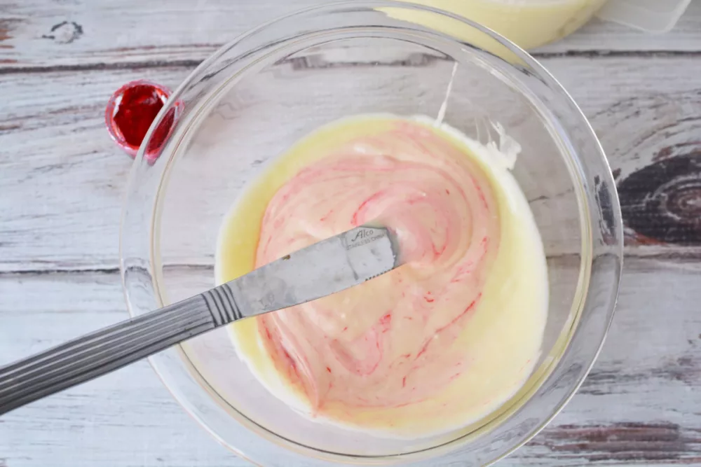 pink cake batter in a mixing bowl