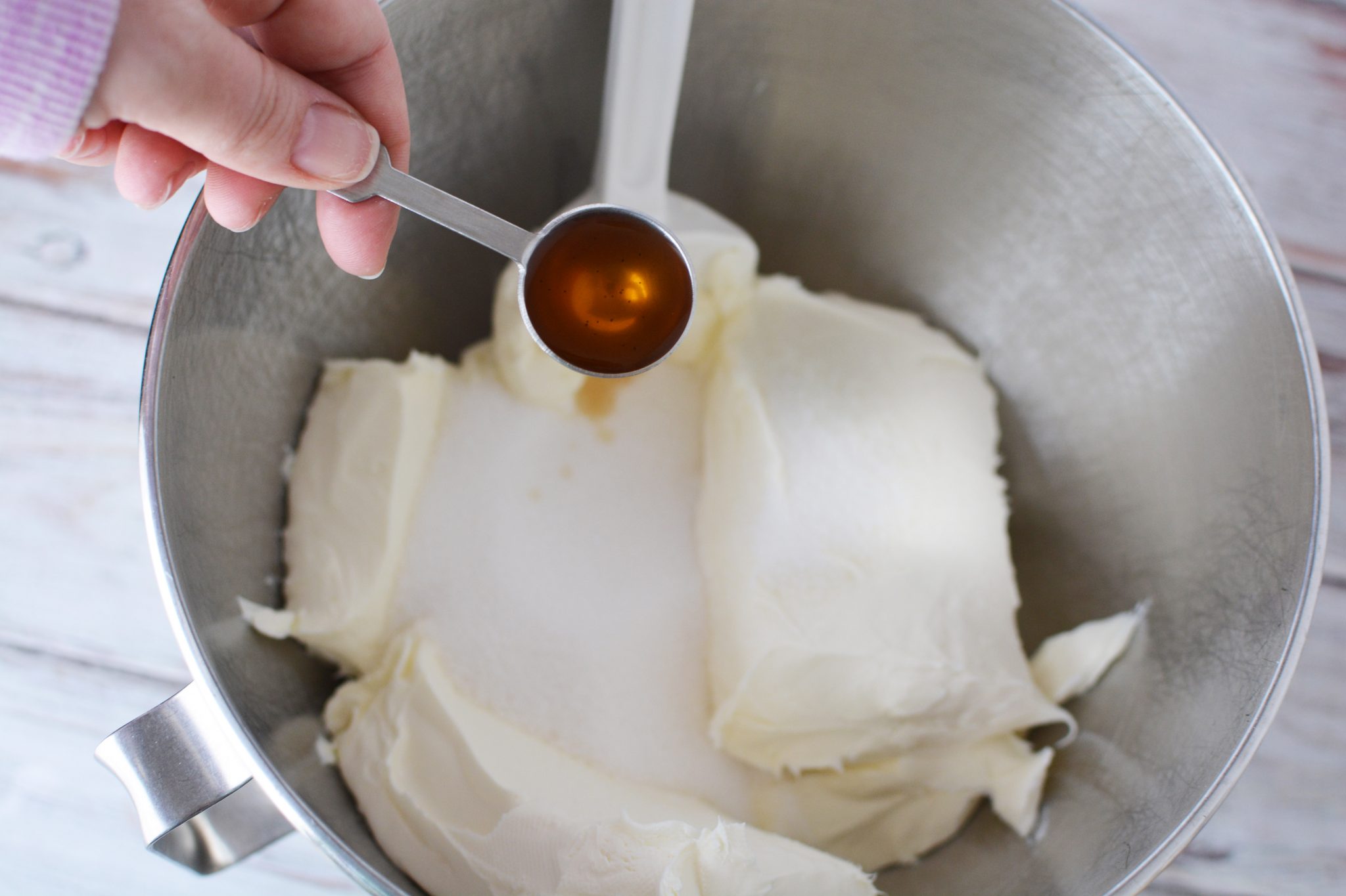 cream cheese and pure vanilla extract in a mixing bowl