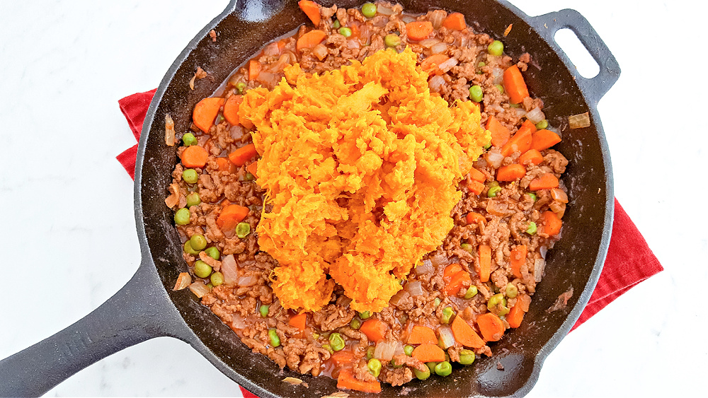 Mashed sweet potatoes on top of ground beef mixture 