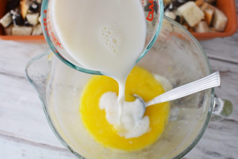 Pouring milk into the egg mixture 