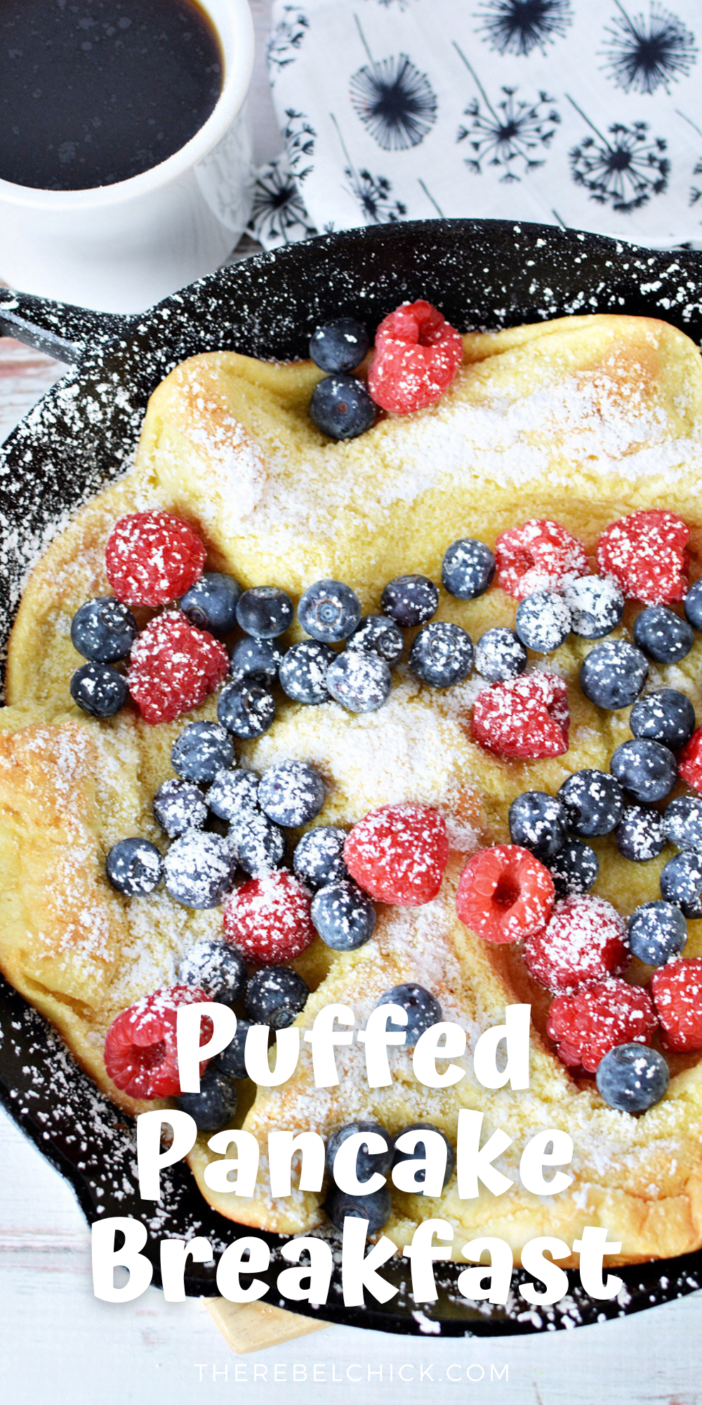 Puffed pancake filled with fresh berries and sprinkled with powdered sugar