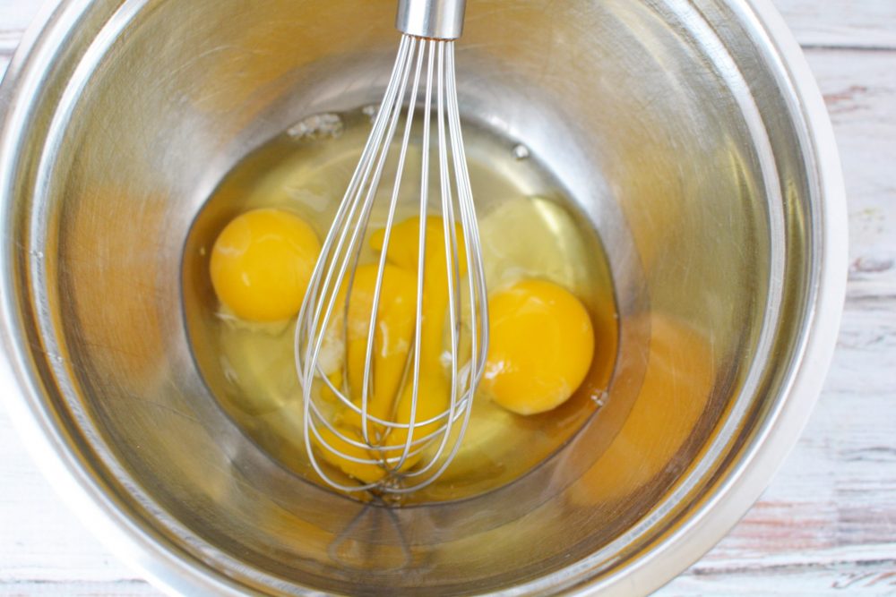 eggs in a mixing bowl with whisk