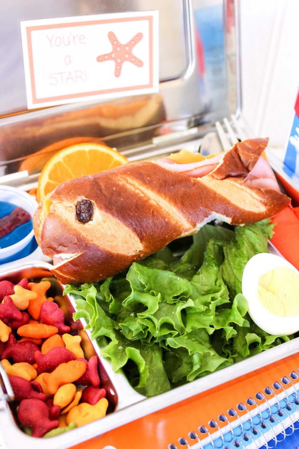 A close-up of a sandwich that is shaped to look like a fish. 
