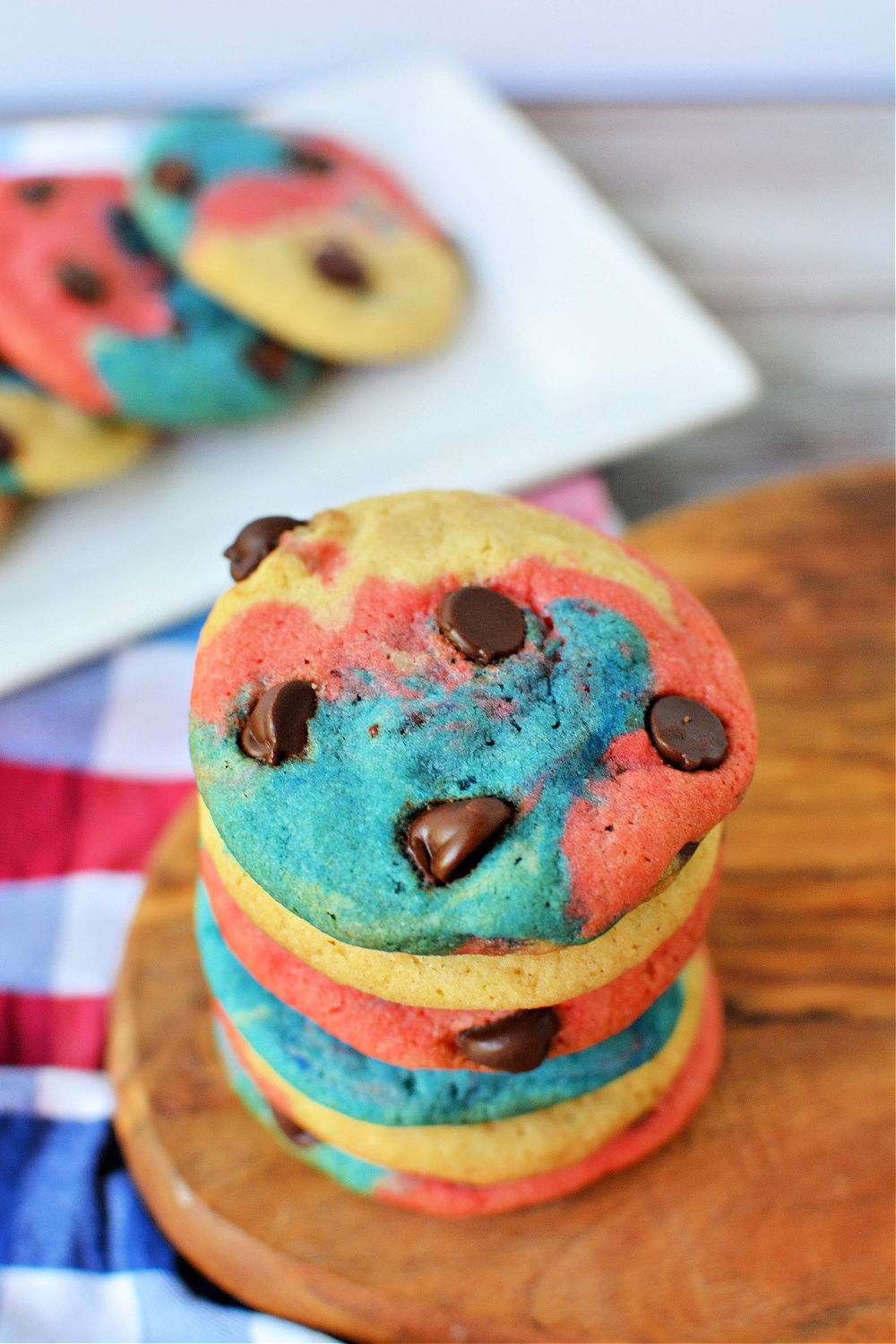 A stack of Red, white and blue cookies on a wood cutting board