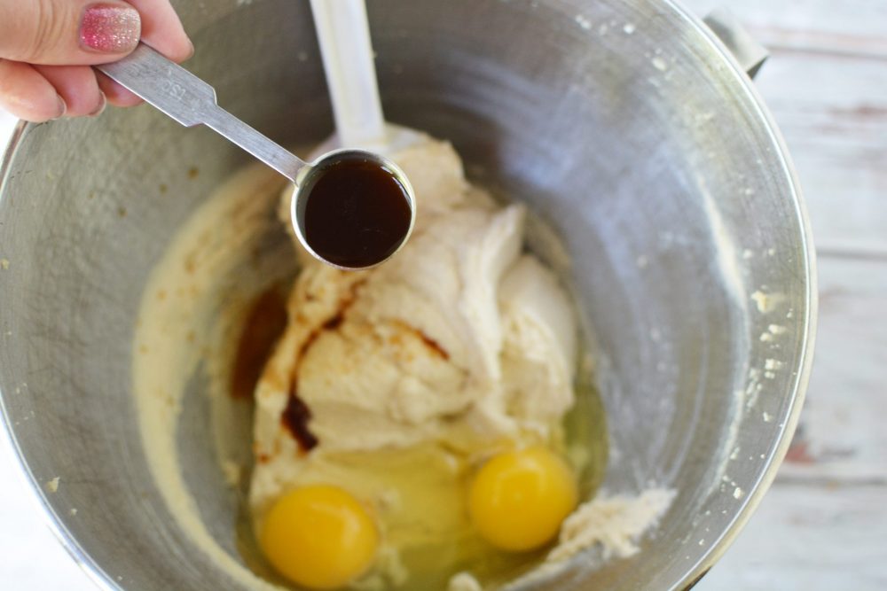 Adding vanilla to the bowl with the eggs