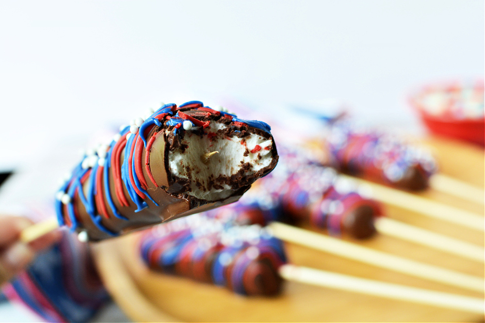 A Red, White & Blue Marshmallow Pop with a bite taken out of it