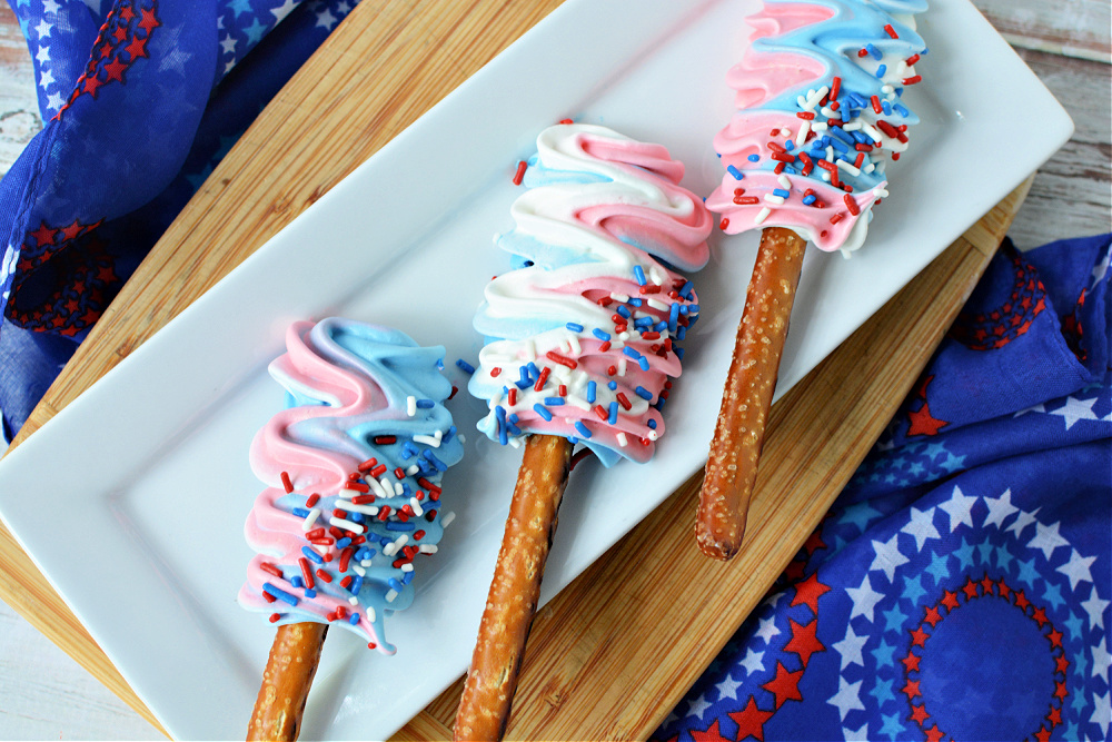 Three Red, White & Blue Meringue Pops On a white plate 