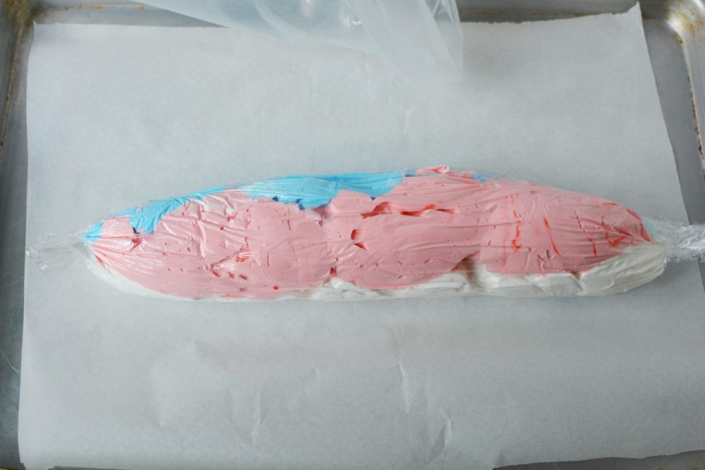 Adding red and blue meringue to a plastic piping bag 