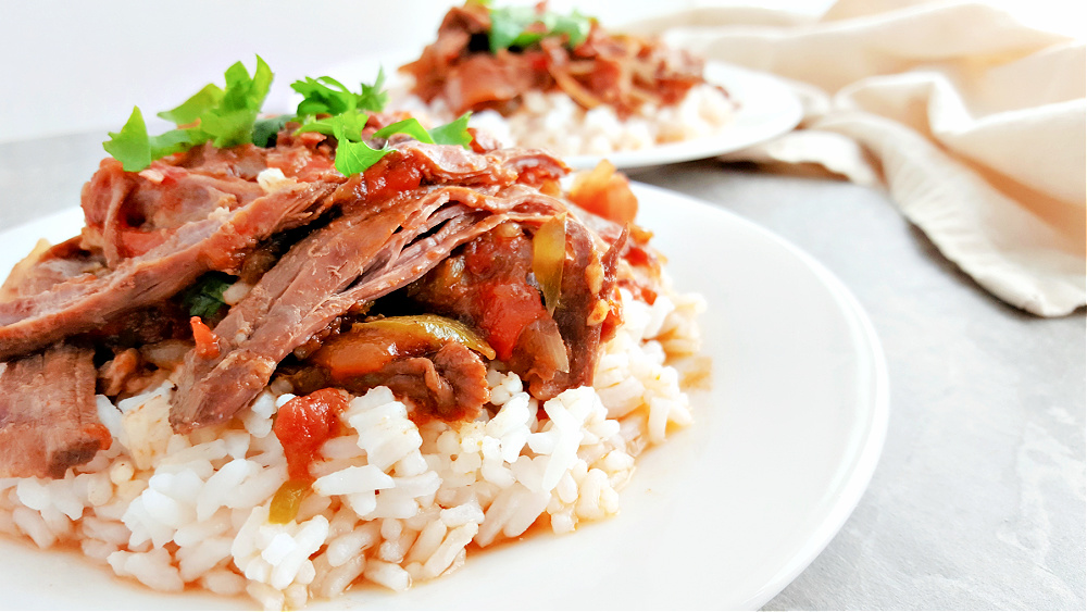 Two plates of Slow Cooker Cuban Ropa Vieja 