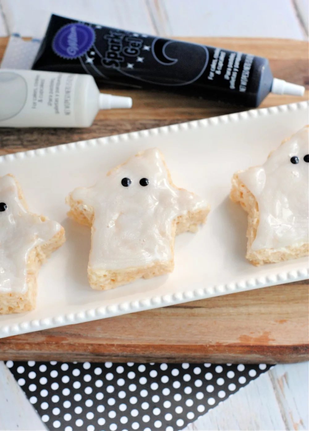 Ghost shaped crisped rice cereal treats with white icing and black eyes