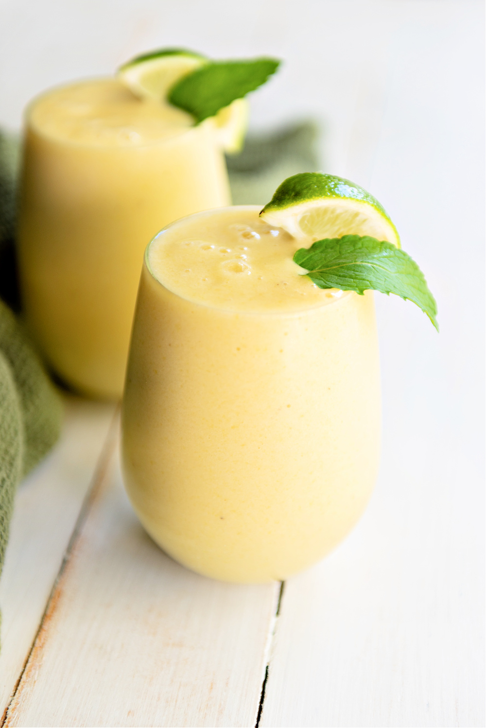 Mango Pineapple Smoothie in a glass with garnish