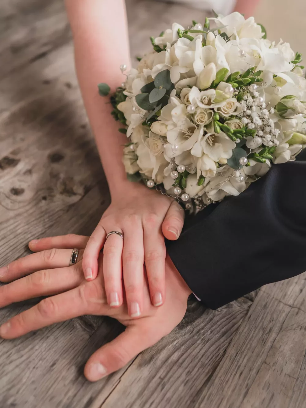bride and grooms hands showing their wedding bands
