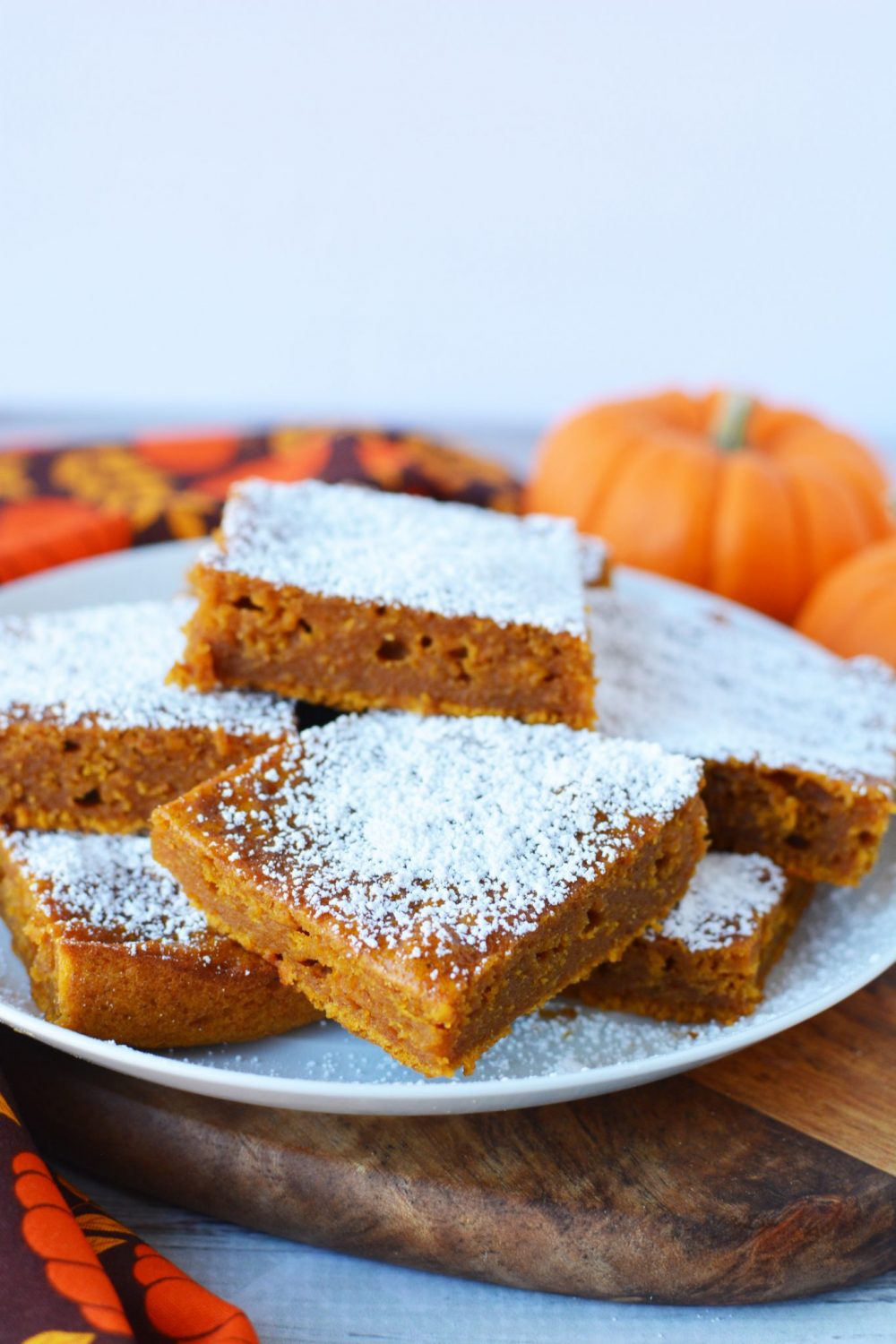 Pumpkin Bars on a plate dusted with powdered sugar
