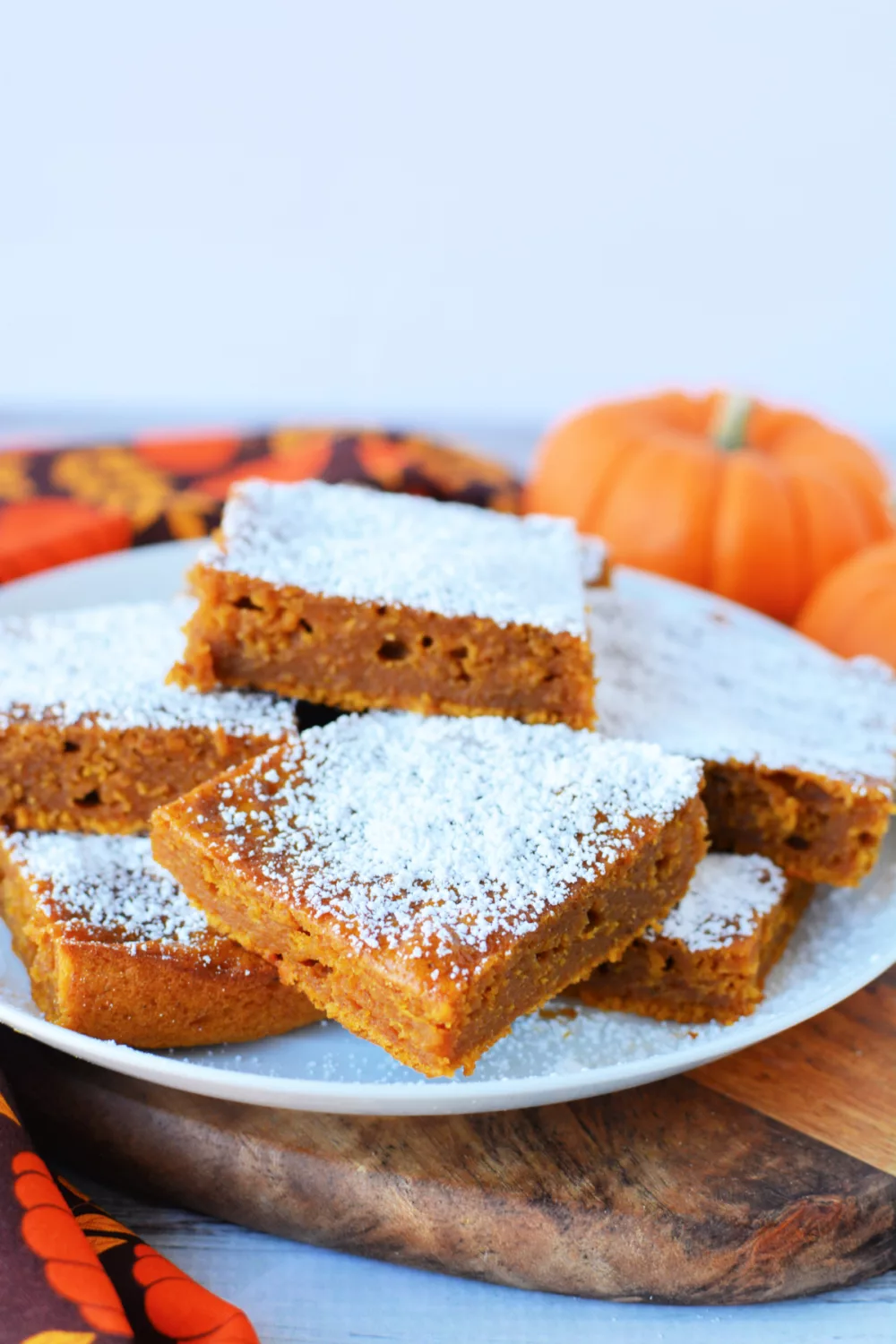 Pumpkin Bars with Cake Mix on a plate covered in powdered sugar