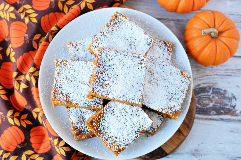 Pumpkin Bars on a plate covered in powdered sugar