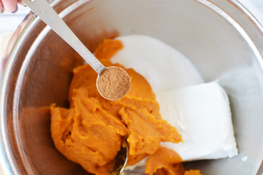 mixing ingredients to make pumpkin cheesecake filling 