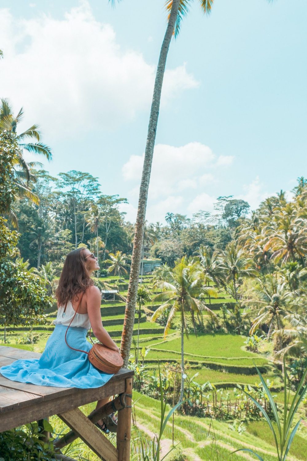 woman admiring a palm tree in Ubud Bali