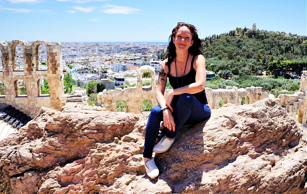 Jennifer Pridemore sitting on a rock in the Acropolis in Athens Greece