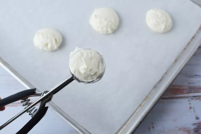 Next, scoop teaspoonfuls of dough onto an ungreased cookie sheet (you can fit about 12 cookies per sheet).