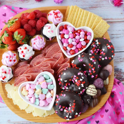 Galentines Charcuterie Board filled with candies, meats, cheeses and sweets in a colorful arrangement